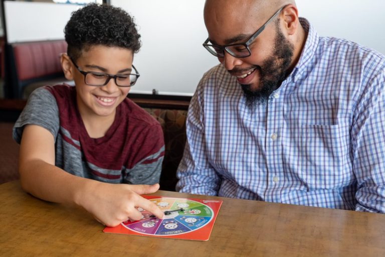 Dad and Son Playing Spinner