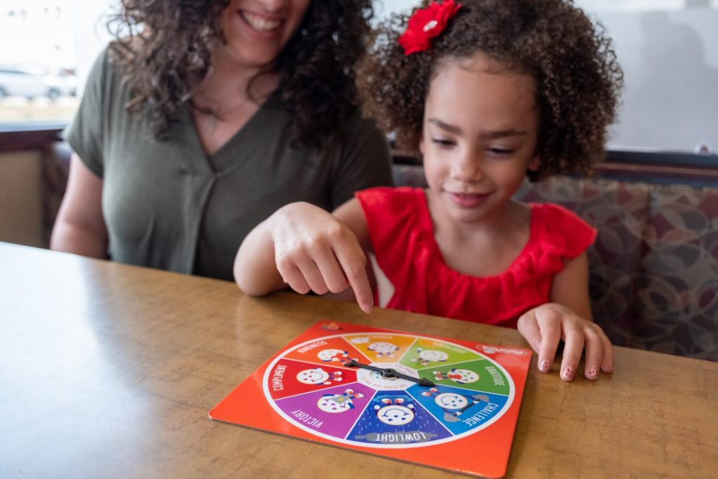 Mom and Daughter Playing Spinner